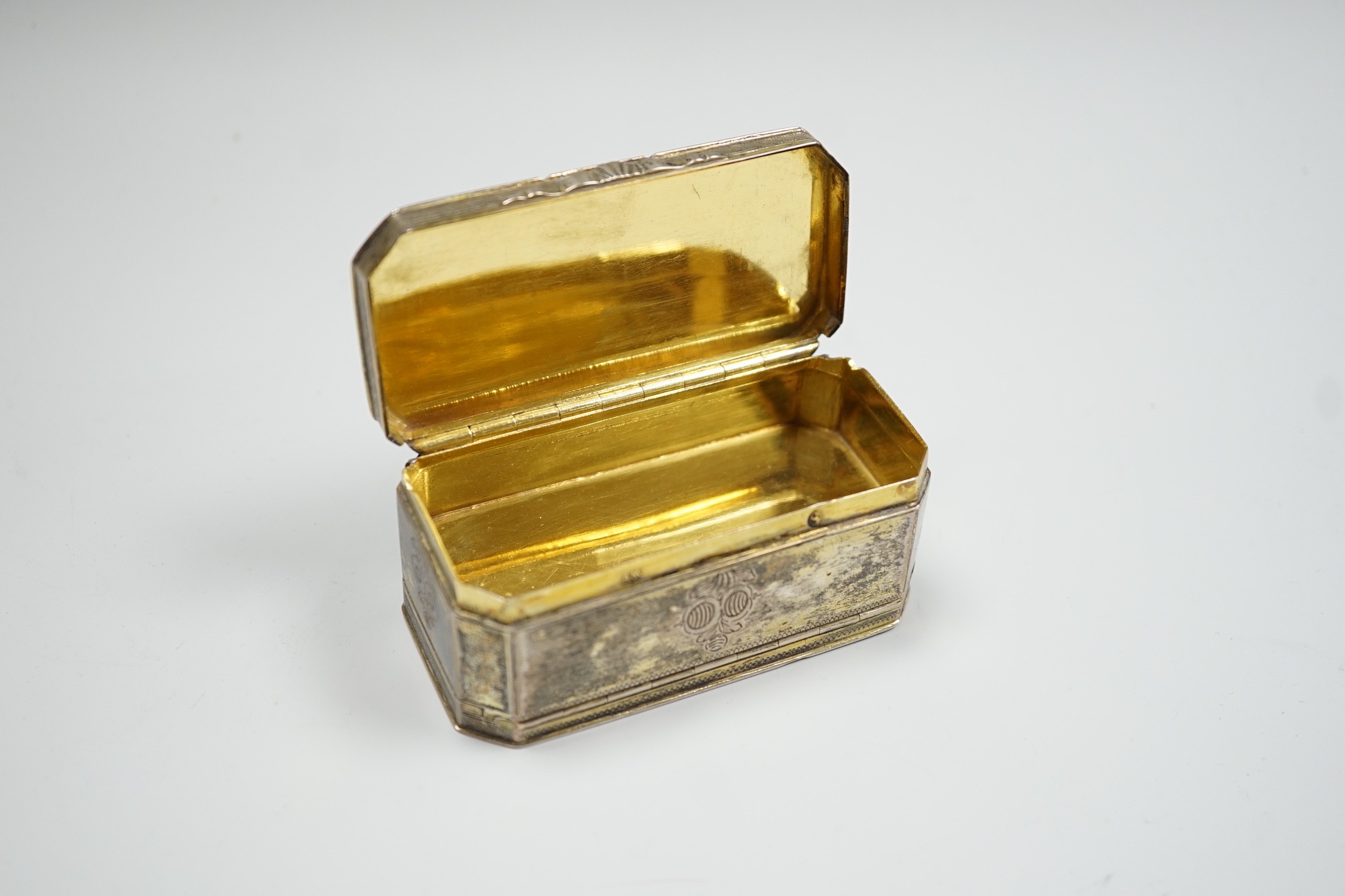 A 19th century German? engraved gilt white metal double hinged octagonal snuff box, 86mm.